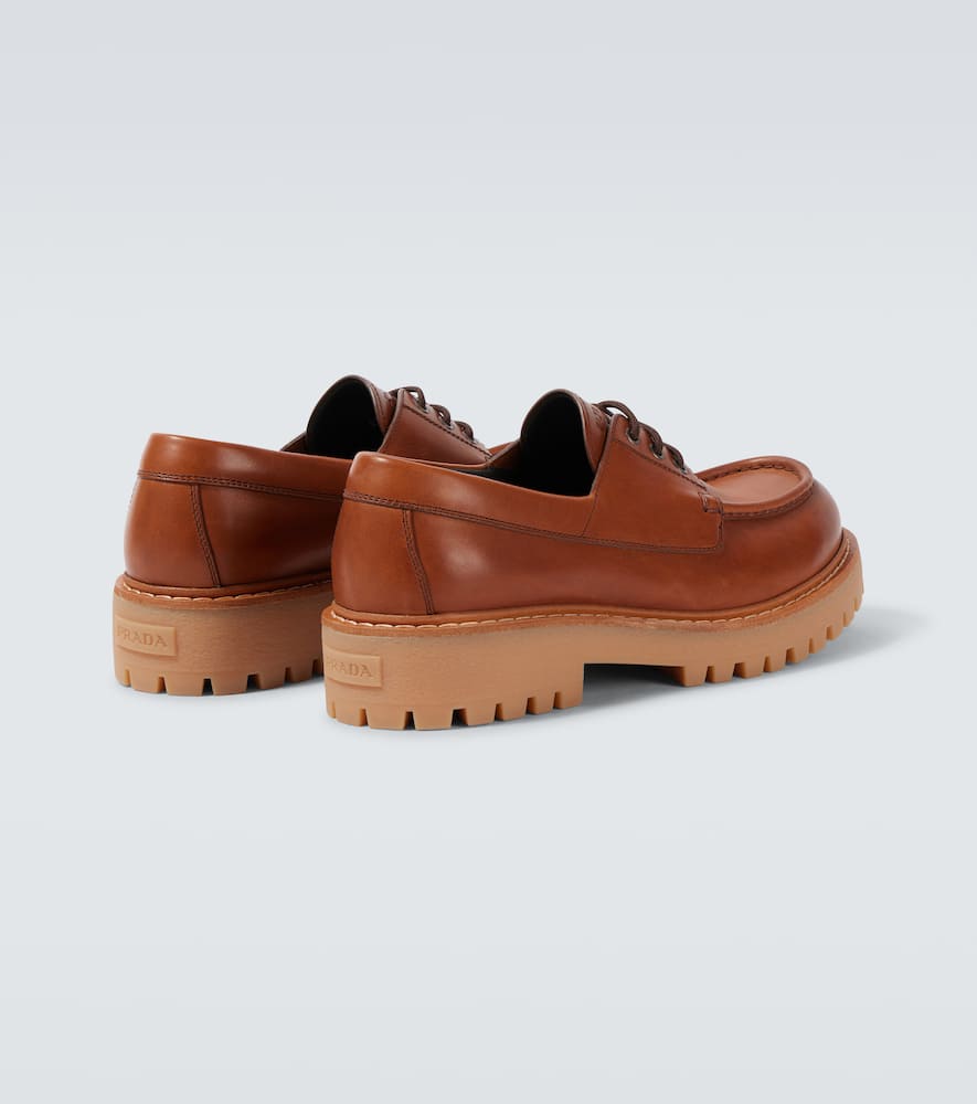 Prada Leather Loafers With Embossed-logo In Brown