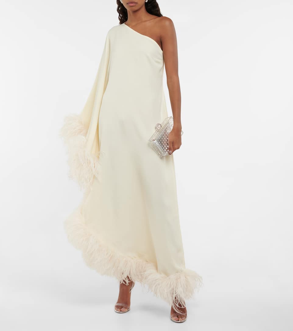 Trimmed with opulent ostrich feathers, Taller Marmo's Ubud gown is a one-shoulder design that arrives at an asymmetric hem.