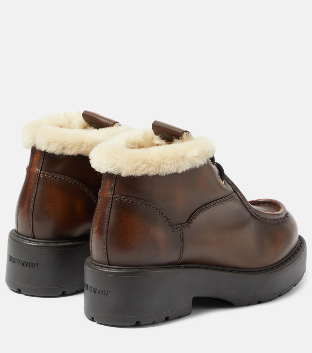 Shearling-trimmed leather ankle boots | Miu Miu