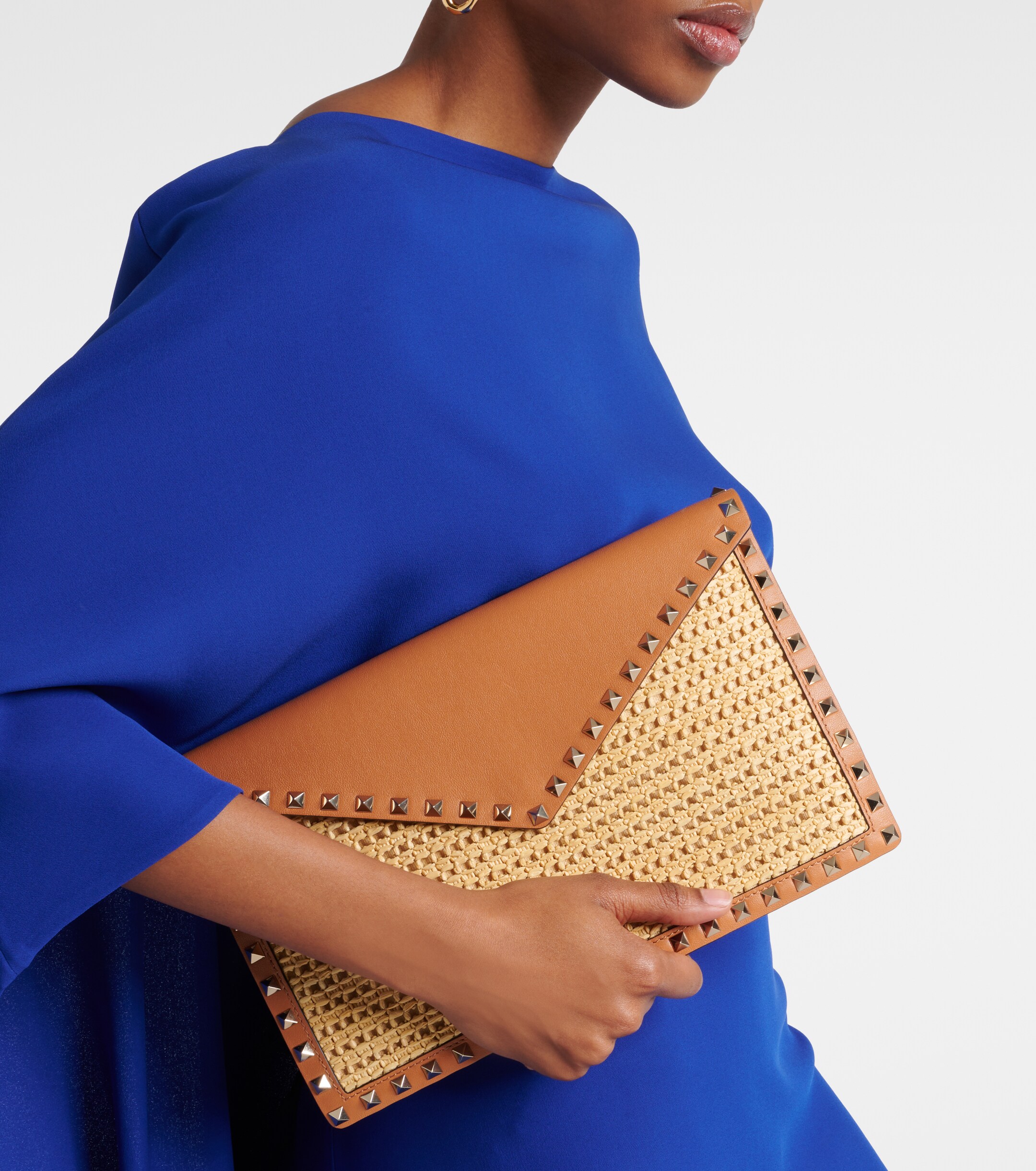 Valentino Garavani Rockstud Large leather-trimmed raffia clutch thumbnail
