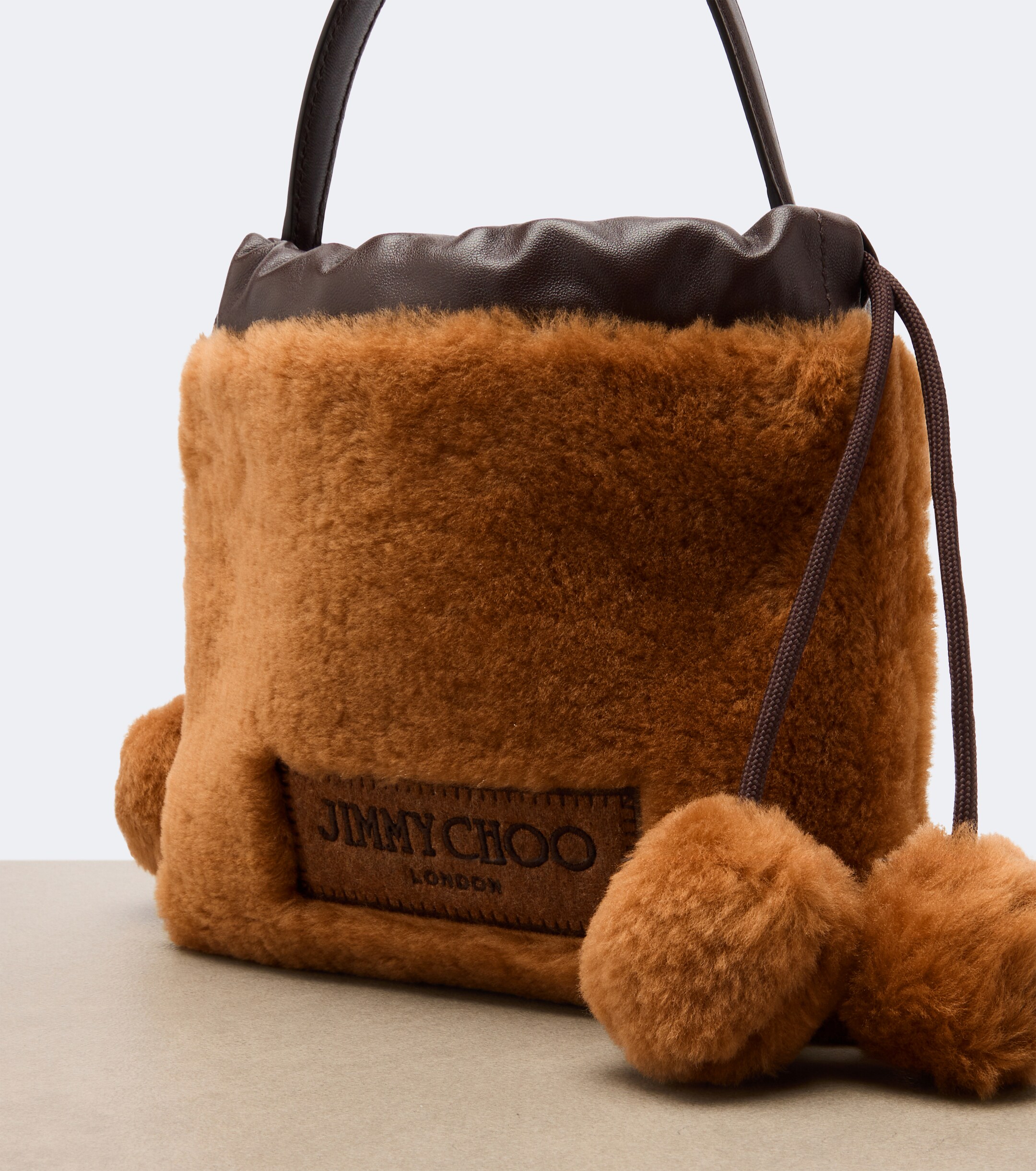 JIMMY CHOO Jimmy Choo Drawstring Mini shearling top-handle bag